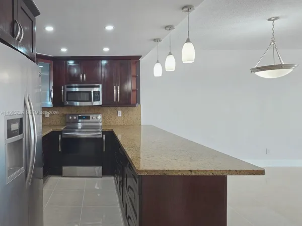 a kitchen with a kitchen island and stainless steel appliances