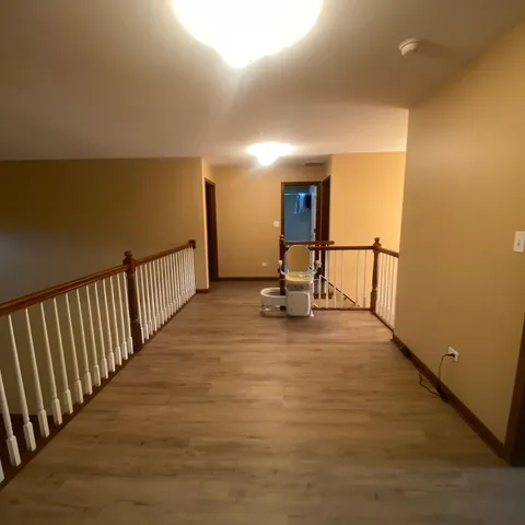 a view of a room with wooden floor
