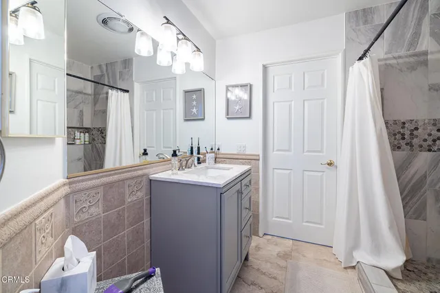 a bathroom with a sink vanity and a mirror