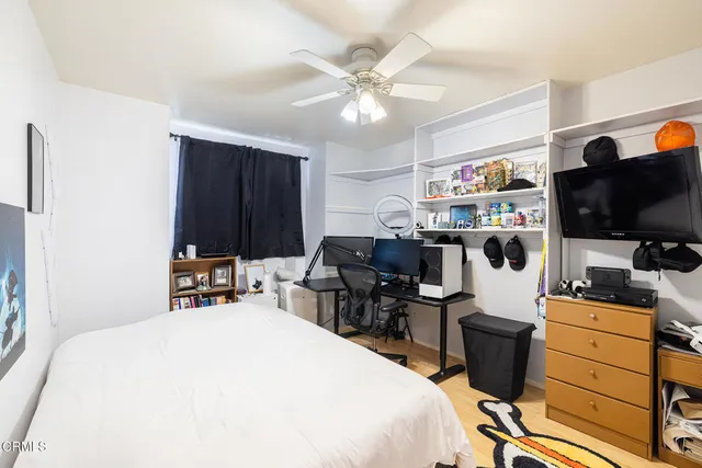 a bed room with a bed and a television