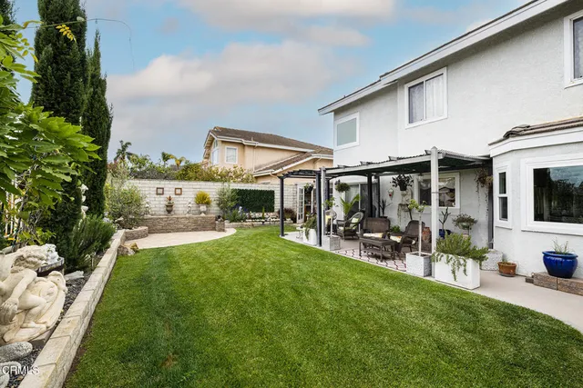 a view of house with backyard porch and outdoor seating