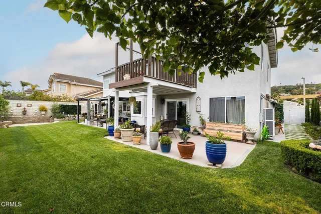 a view of a house with backyard porch and sitting area