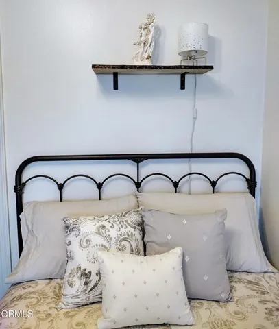 a bedroom with a bed and a black white bedspread