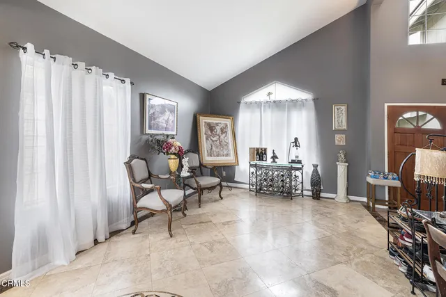 a living room with furniture and a large mirror
