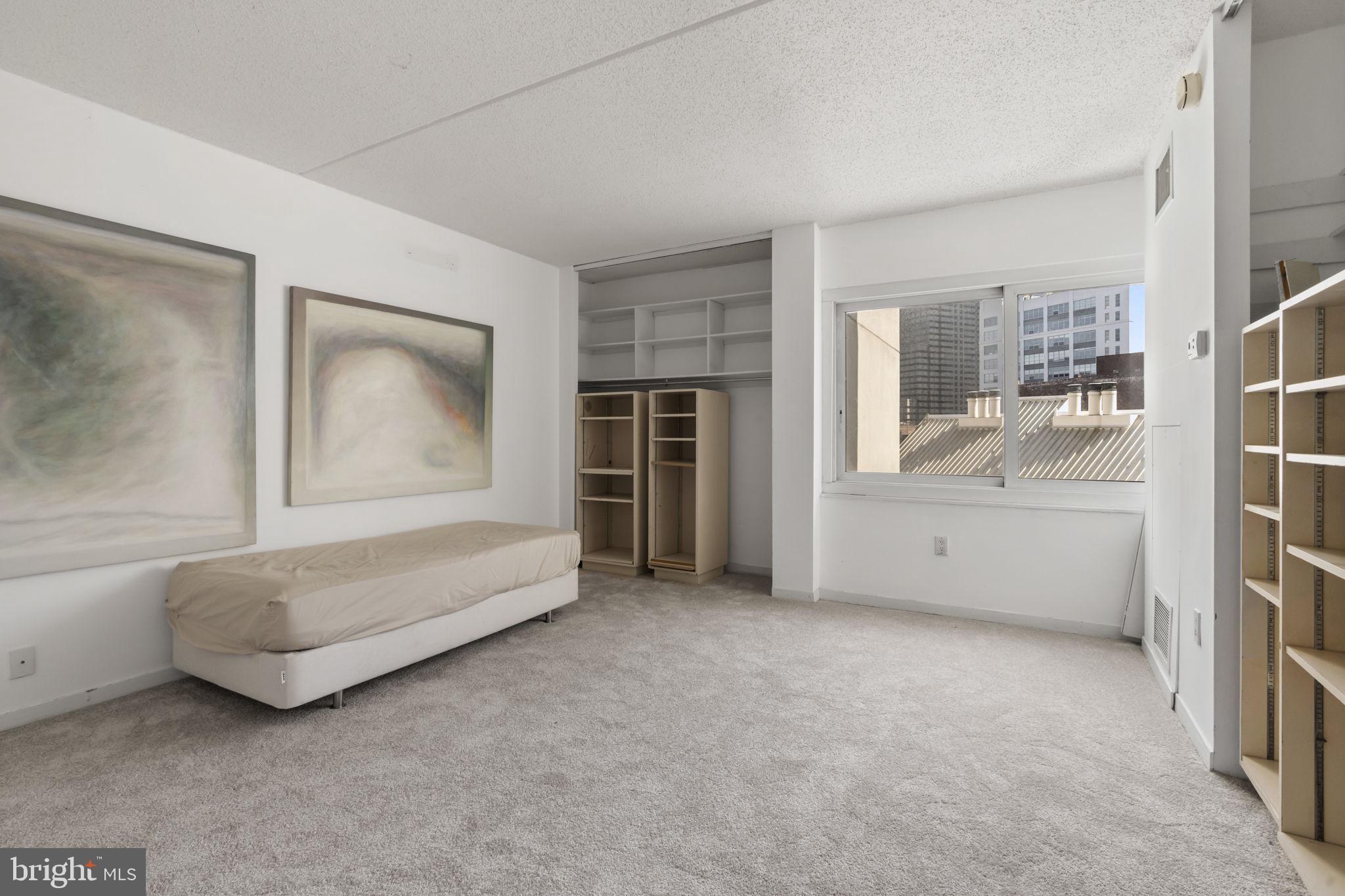 2301 Cherry Street, Unit 6F Philadelphia, PA 19103 - Photo 17 of 30 a view of an empty room with a fireplace and cabinet