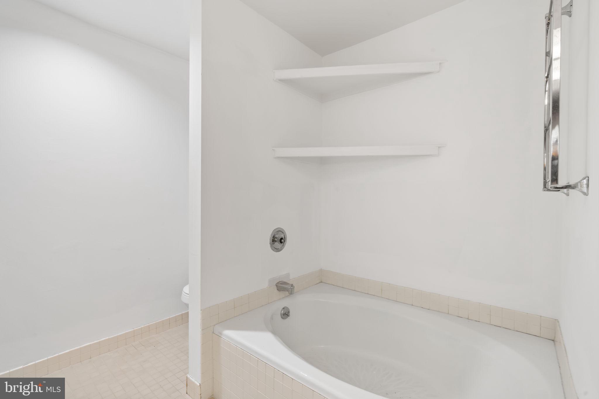 2301 Cherry Street, Unit 6F Philadelphia, PA 19103 - Photo 20 of 30 a white bath tub and shower
