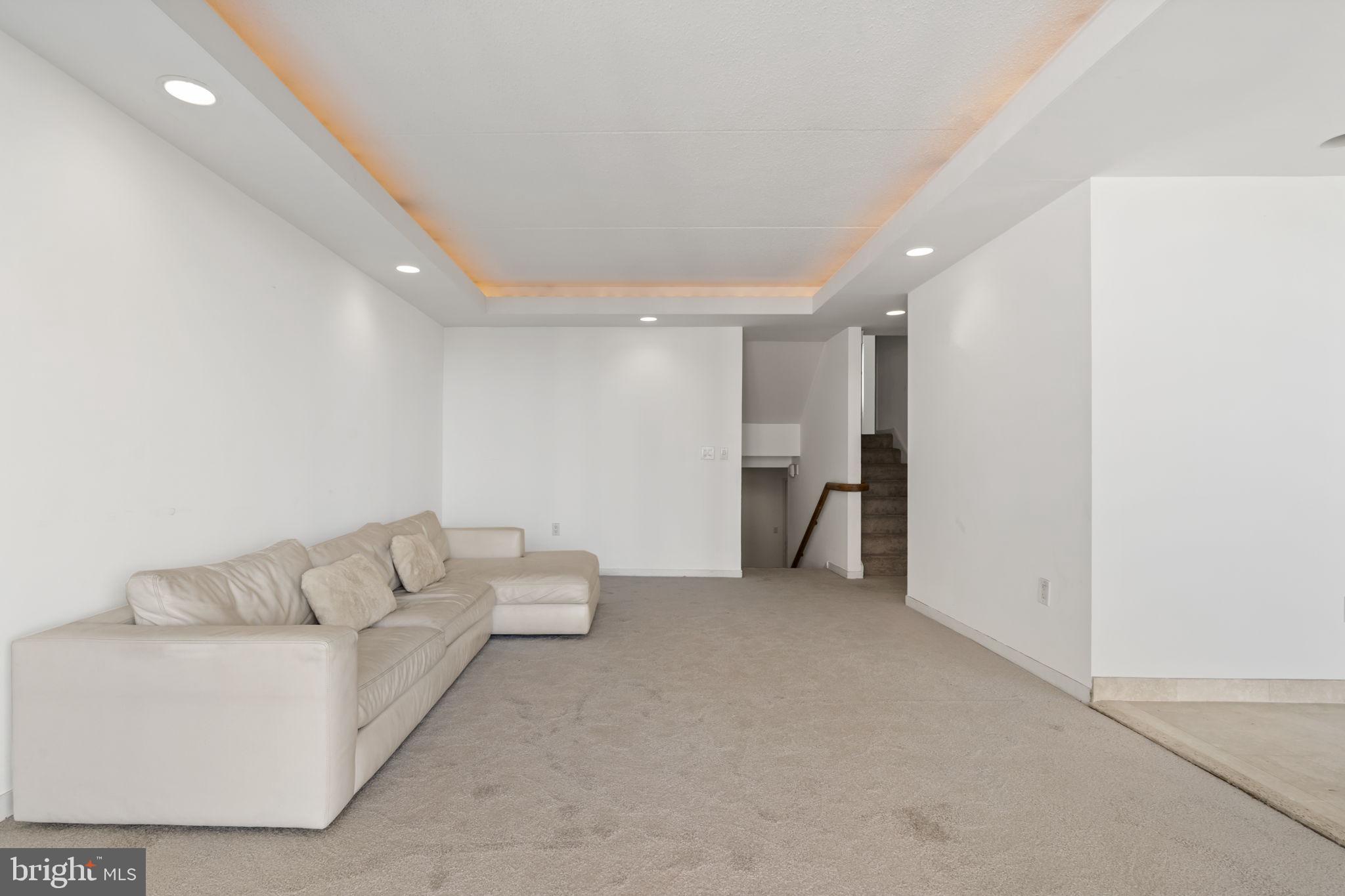 2301 Cherry Street, Unit 6F Philadelphia, PA 19103 - Photo 7 of 30 a living room with furniture and a walk in closet with wooden floor