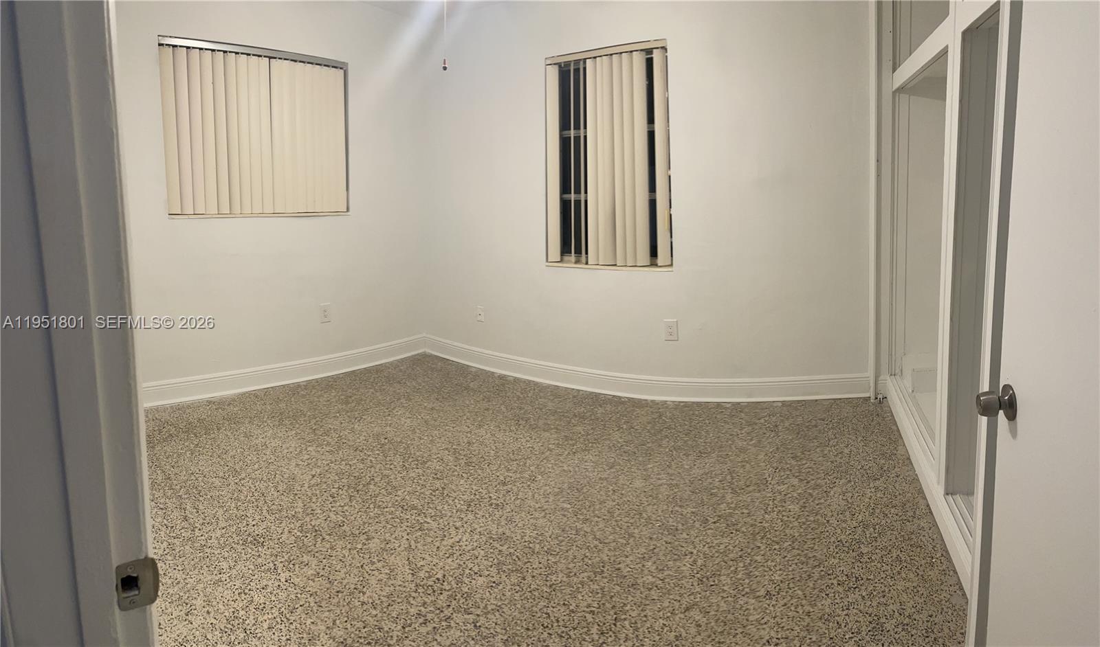 9810 Southwest 165th Terrace, Unit 9810 Miami, FL 33157 - Photo 7 of 17 an empty room with windows