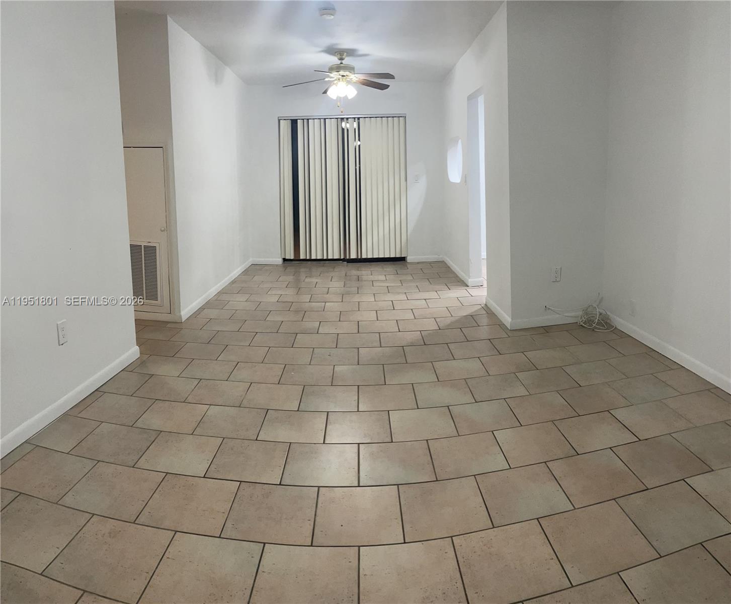 9810 Southwest 165th Terrace, Unit 9810 Miami, FL 33157 - Photo 8 of 17 an empty room with white walls and tiles