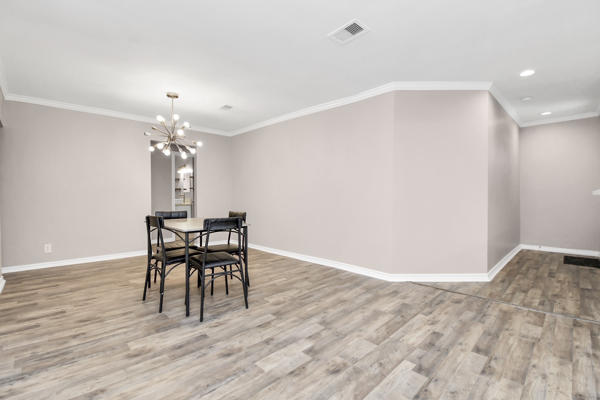 3743 Odin Court Houston, TX 77021 - Photo 13 of 36 Fluid and functional gathering space. Smooth, wood-look flooring anchors a generous room dressed in light neutrals, offering an adaptable footprint that easily combines sophisticated dining and spacious lounging.