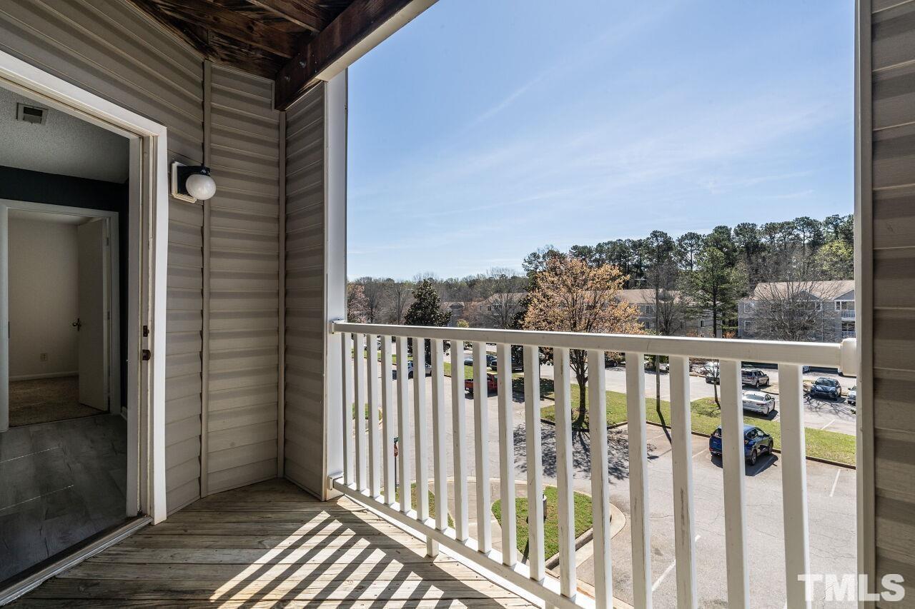 1230 University Court, Unit 204 Raleigh, NC 27606 - Photo 12 of 17 a view of a balcony with wooden floor and fence
