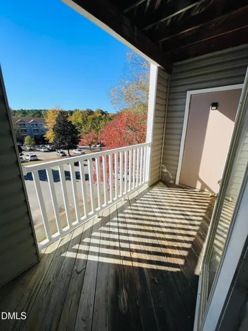 a view of a balcony with wooden floor