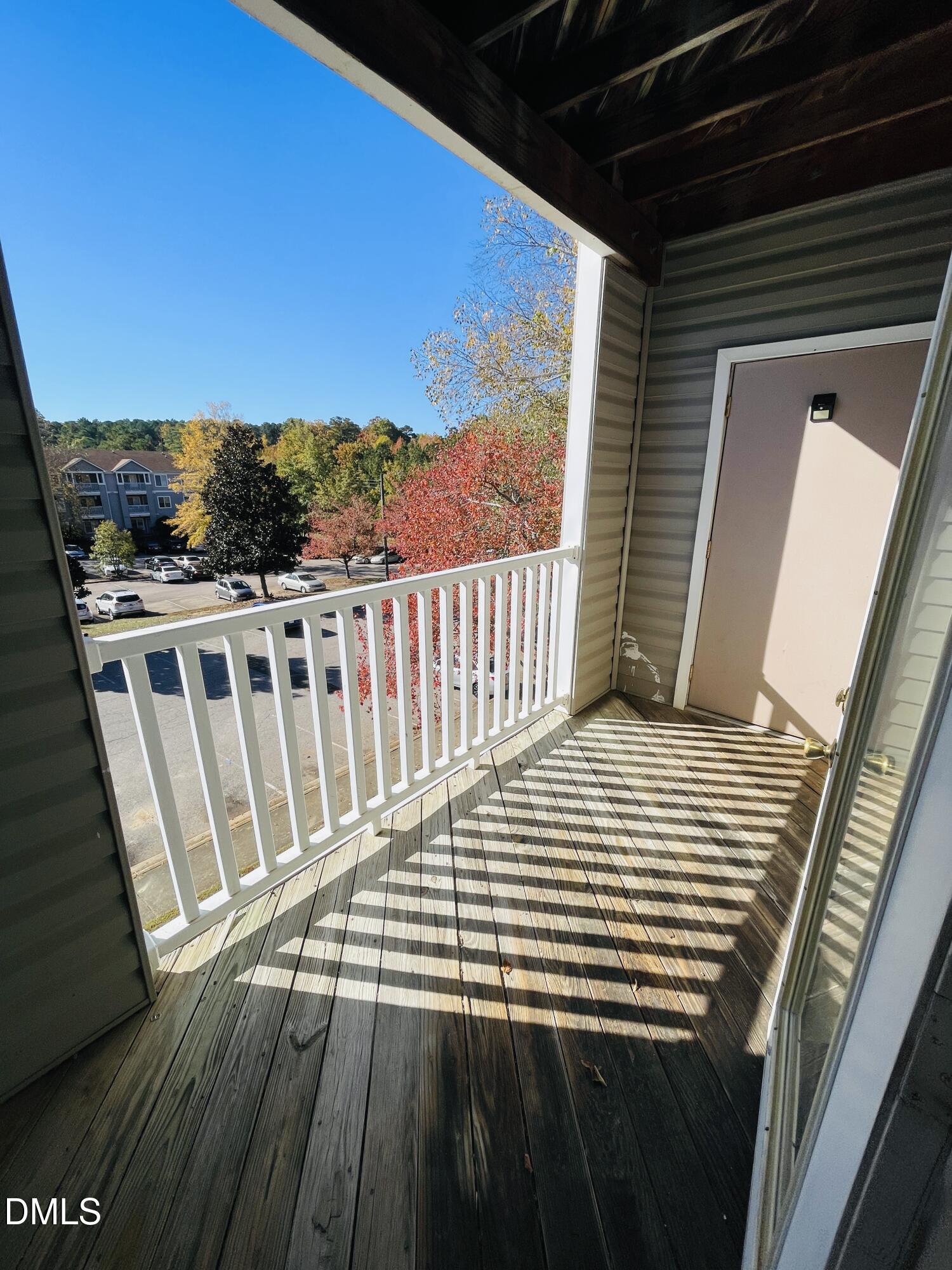 1230 University Court, Unit 204 Raleigh, NC 27606 - Photo 13 of 17 a view of a balcony with wooden floor
