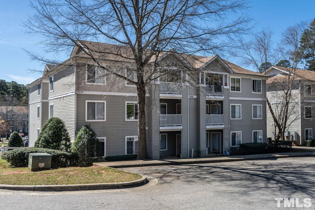 1230 University Court, Unit 204 Raleigh, NC 27606 - Photo 14 of 17 a front view of a house with a yard