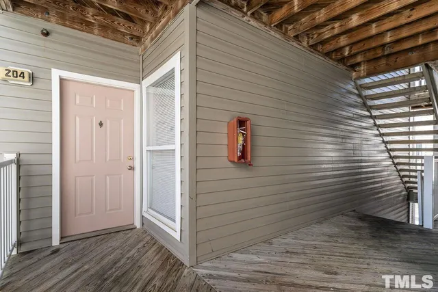 a view of a door and wooden deck
