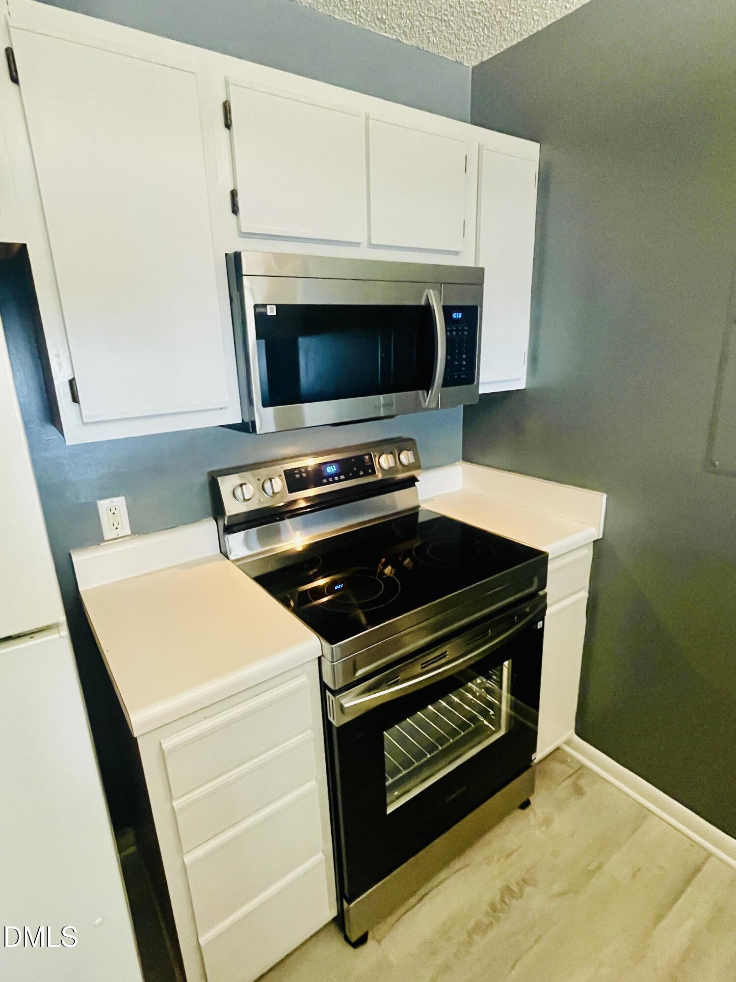 1230 University Court, Unit 204 Raleigh, NC 27606 - Photo 2 of 17 a stove top oven sitting inside of a kitchen