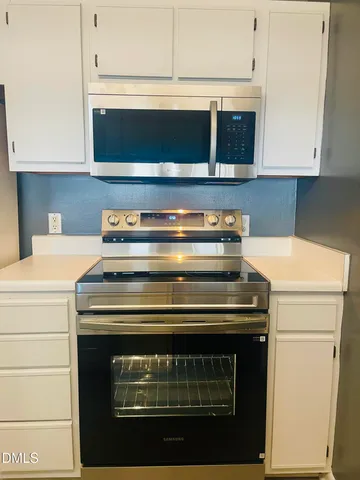 a stove top oven sitting inside of a kitchen