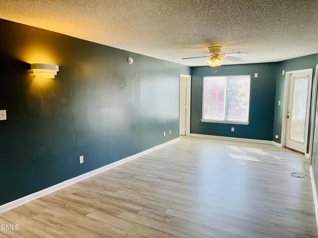 a view of empty room with a windows