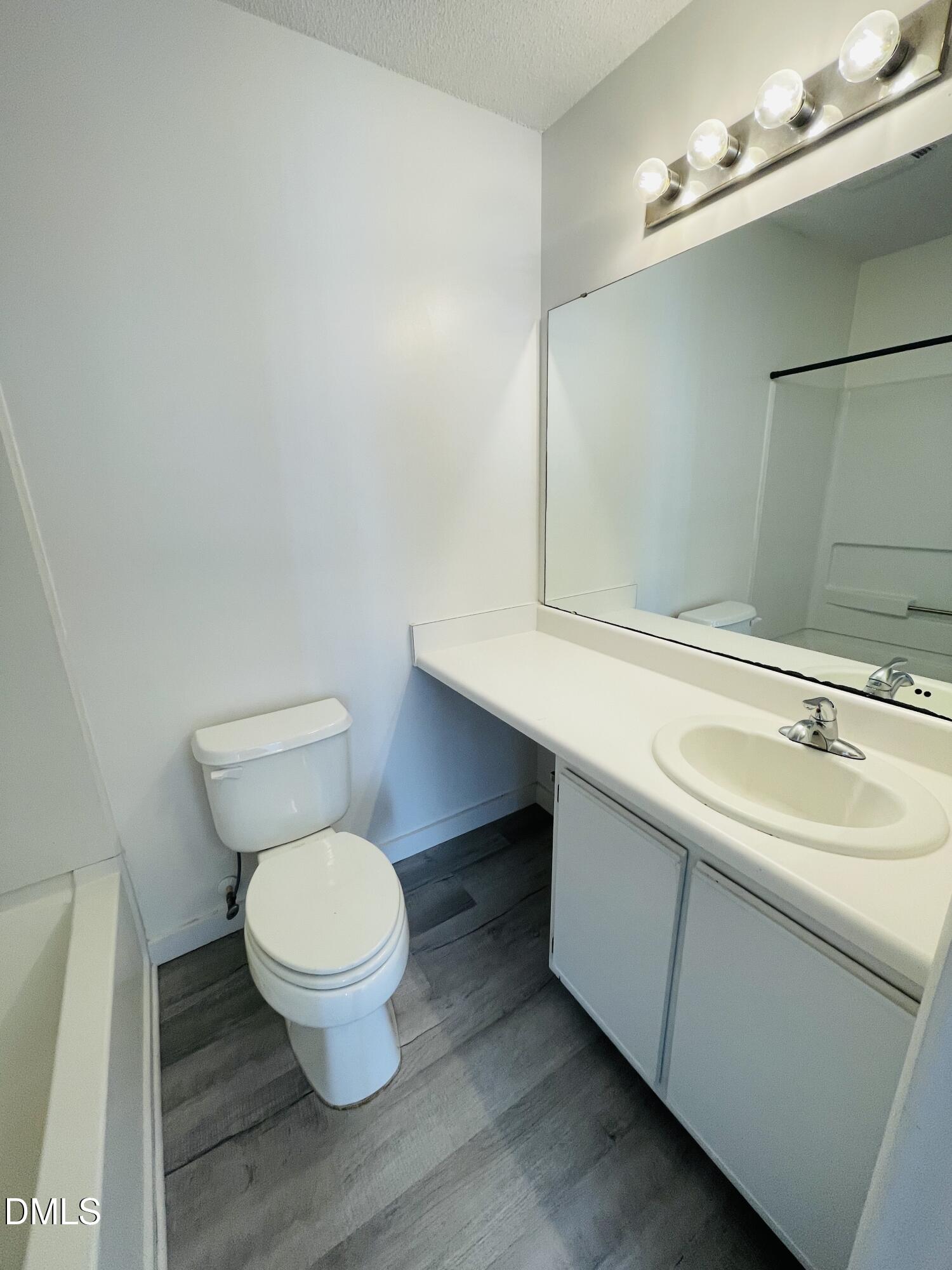 1230 University Court, Unit 204 Raleigh, NC 27606 - Photo 8 of 17 a bathroom with a toilet sink and mirror