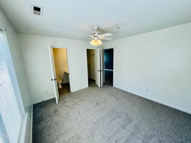 an empty room with a view of a bathroom