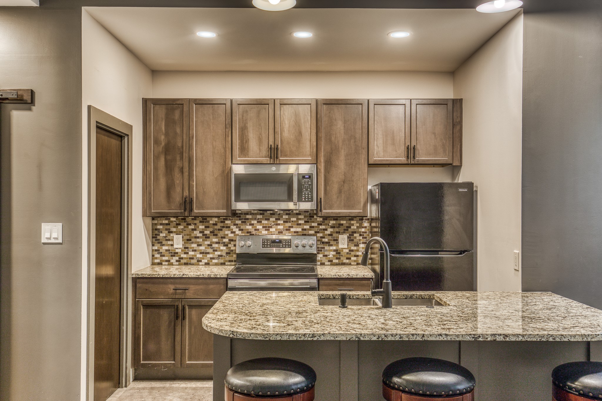 5280 Whitaker Way Navasota, TX 77868 - Photo 12 of 21 a kitchen with kitchen island granite countertop counter top space cabinets and stainless steel appliances