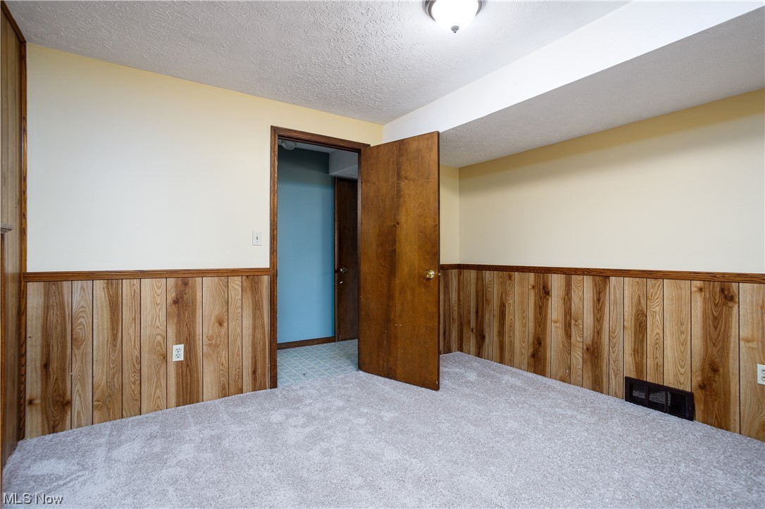 5680 Lance Road Medina, OH 44256 - Photo 22 of 32 Carpeted empty room featuring a textured ceiling