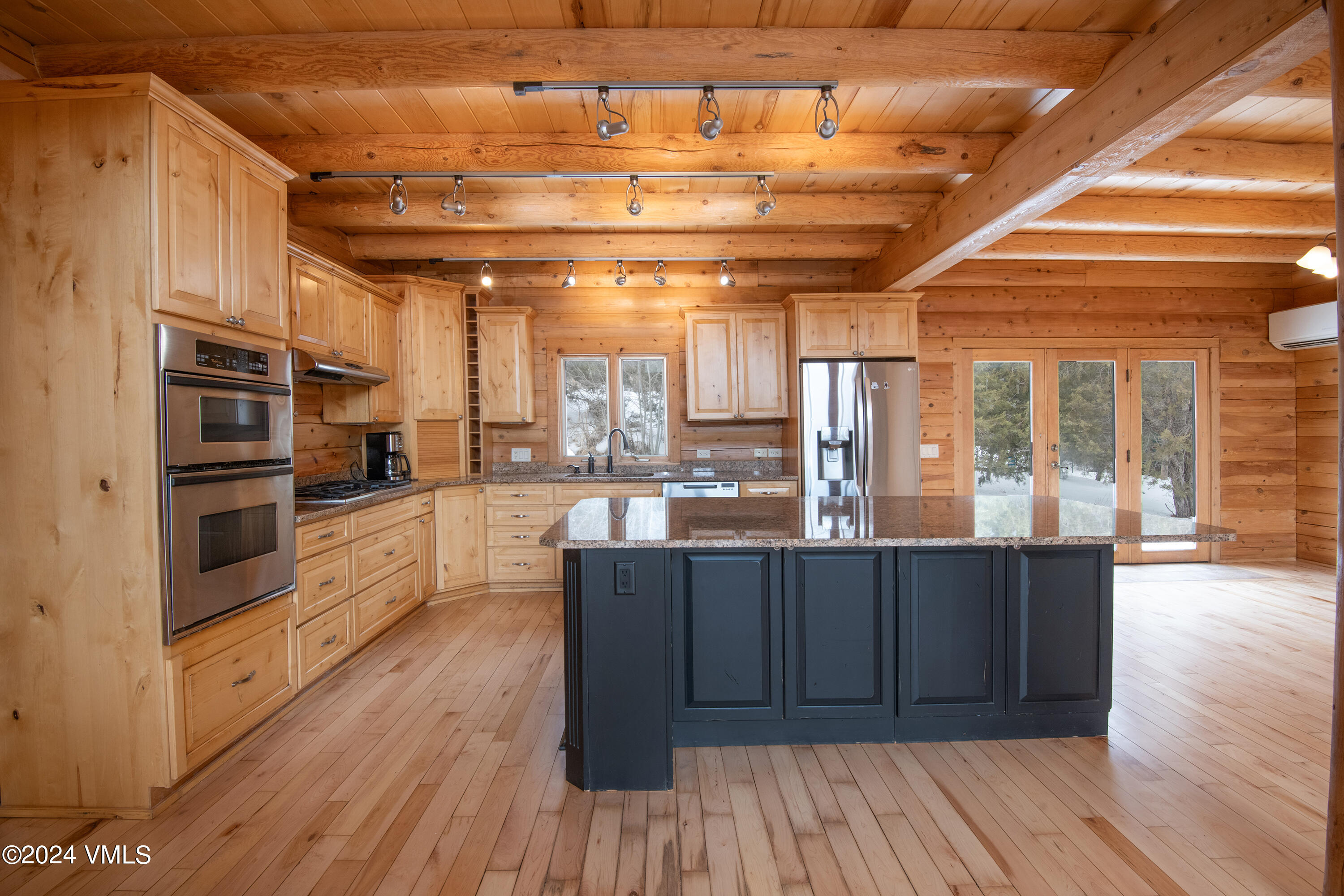 336 Castle Peak Road Eagle, CO 81631 - Photo 7 of 52 a kitchen with wooden floors and wooden cabinets