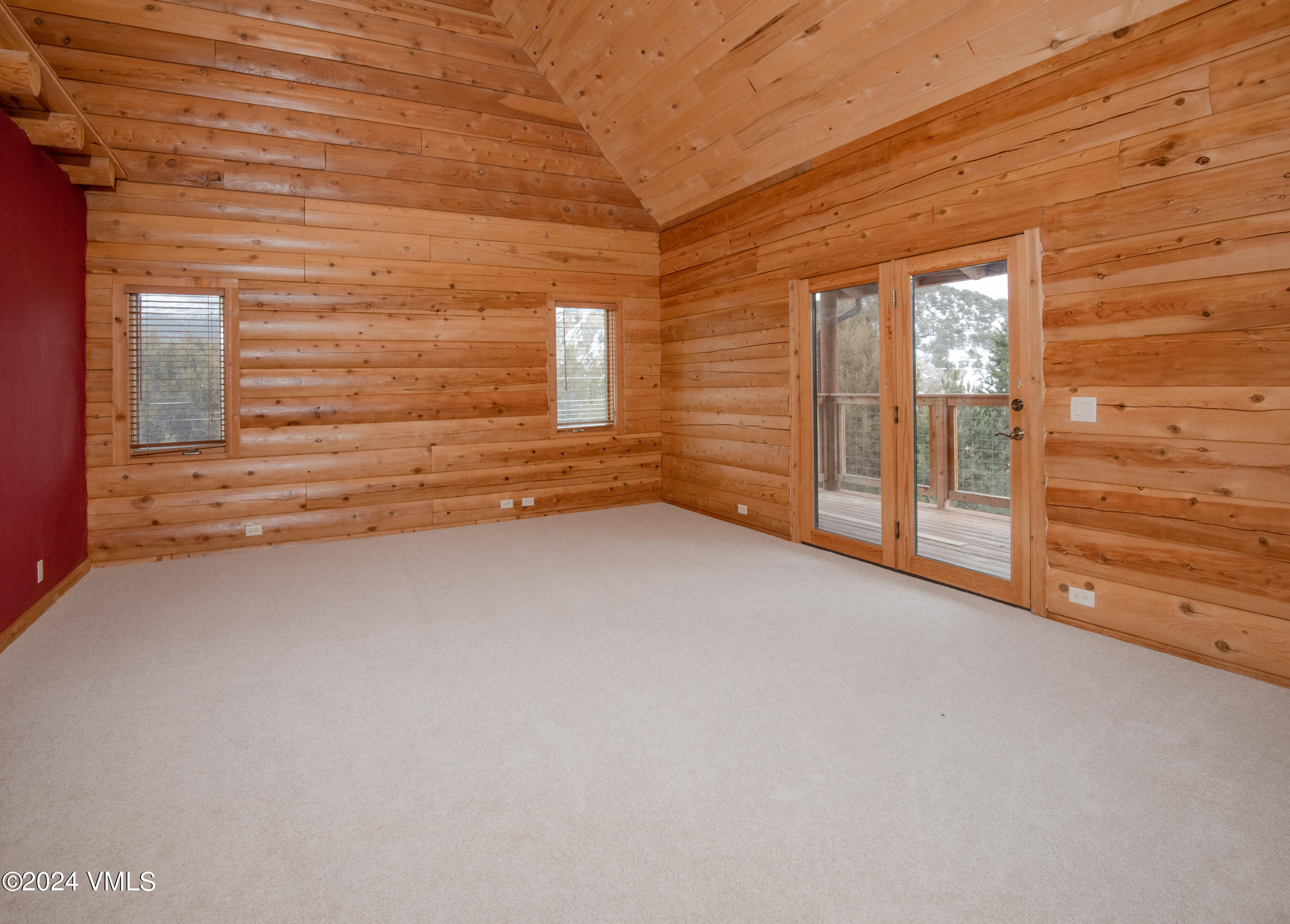 336 Castle Peak Road Eagle, CO 81631 - Photo 10 of 52 a view of an empty room with wooden floor and a window