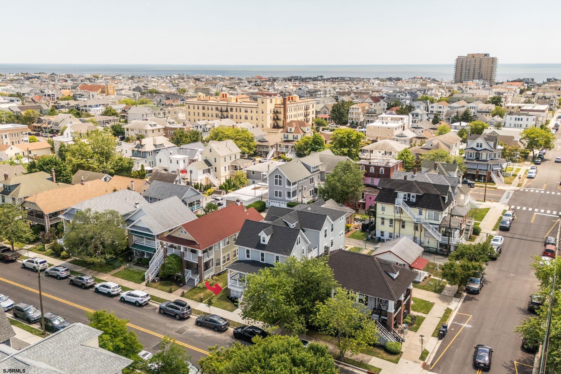 an aerial view of residential houses with city view