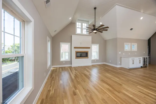 a view of a room with wooden floor and chandelier