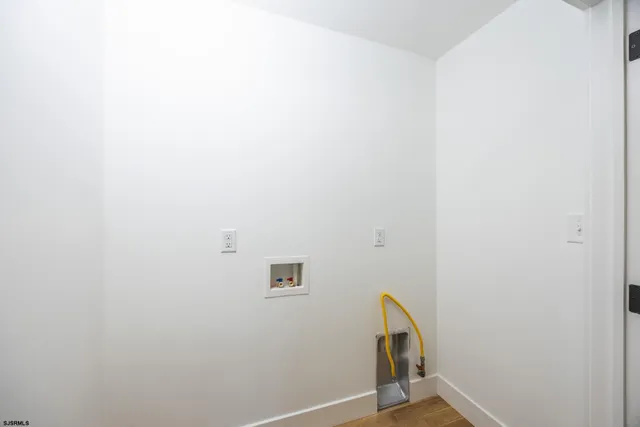 a view of room with a ceiling fan and wooden floor