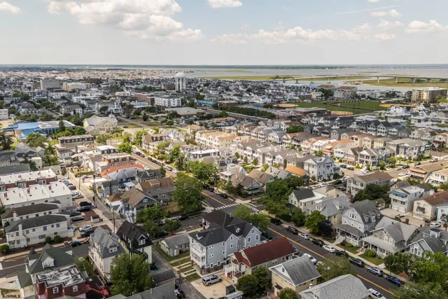 an aerial view of a city with lots of residential buildings and ocean view