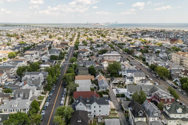 an aerial view of residential houses with city view