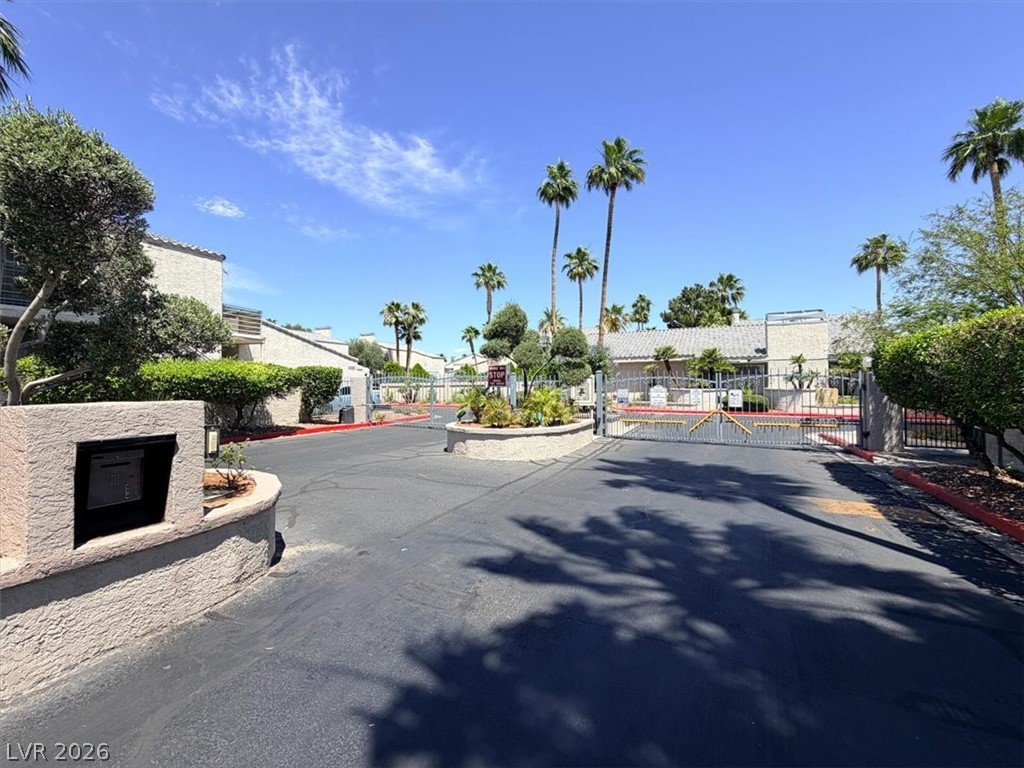 6250 West Flamingo Road, Unit 93 Las Vegas, NV 89103 - Photo 34 of 38 This gated community features lush landscaping, providing a private and inviting entrance.