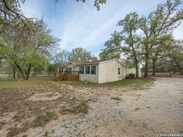 135 Savannah Ridge Von Ormy, TX 78073 - Photo 8 of 45 a house with trees in the background