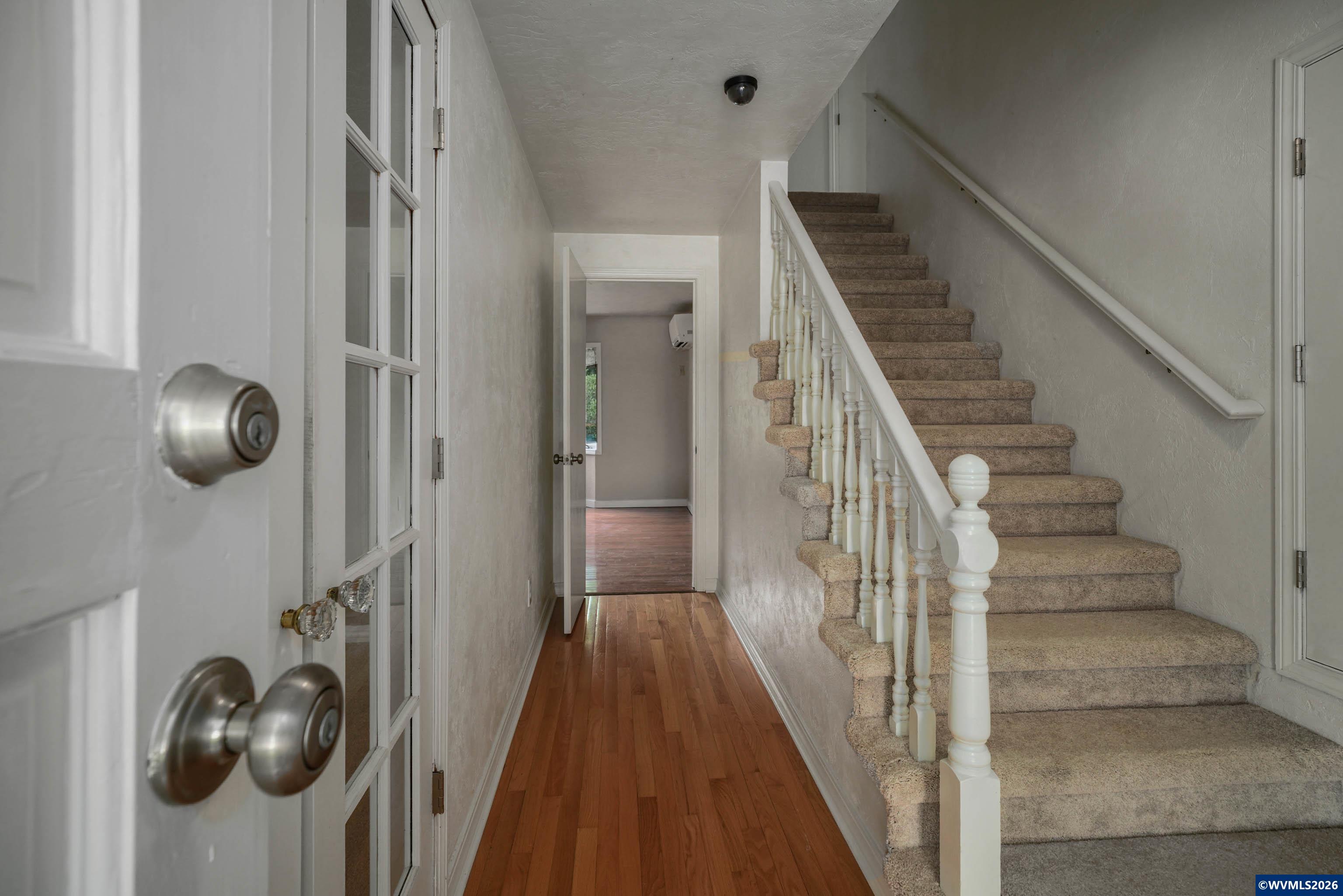 220 Northwest Downy Drive Sublimity, OR 97385 - Photo 5 of 47 a view of a hallway with wooden floor and staircase