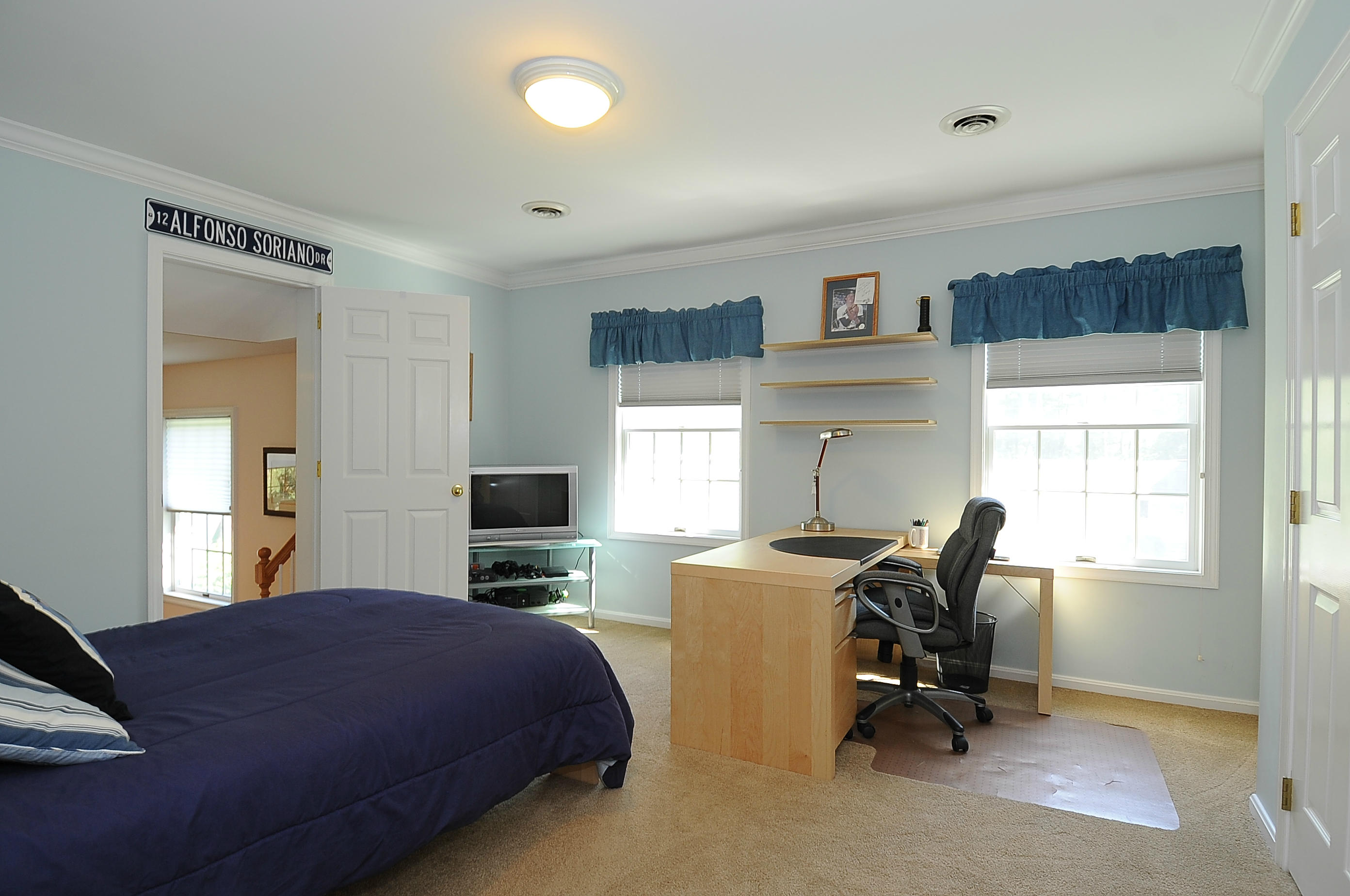 54 Conrad Road New Canaan, CT 06840 - Photo 16 of 21 a bedroom with a bed a table and chair