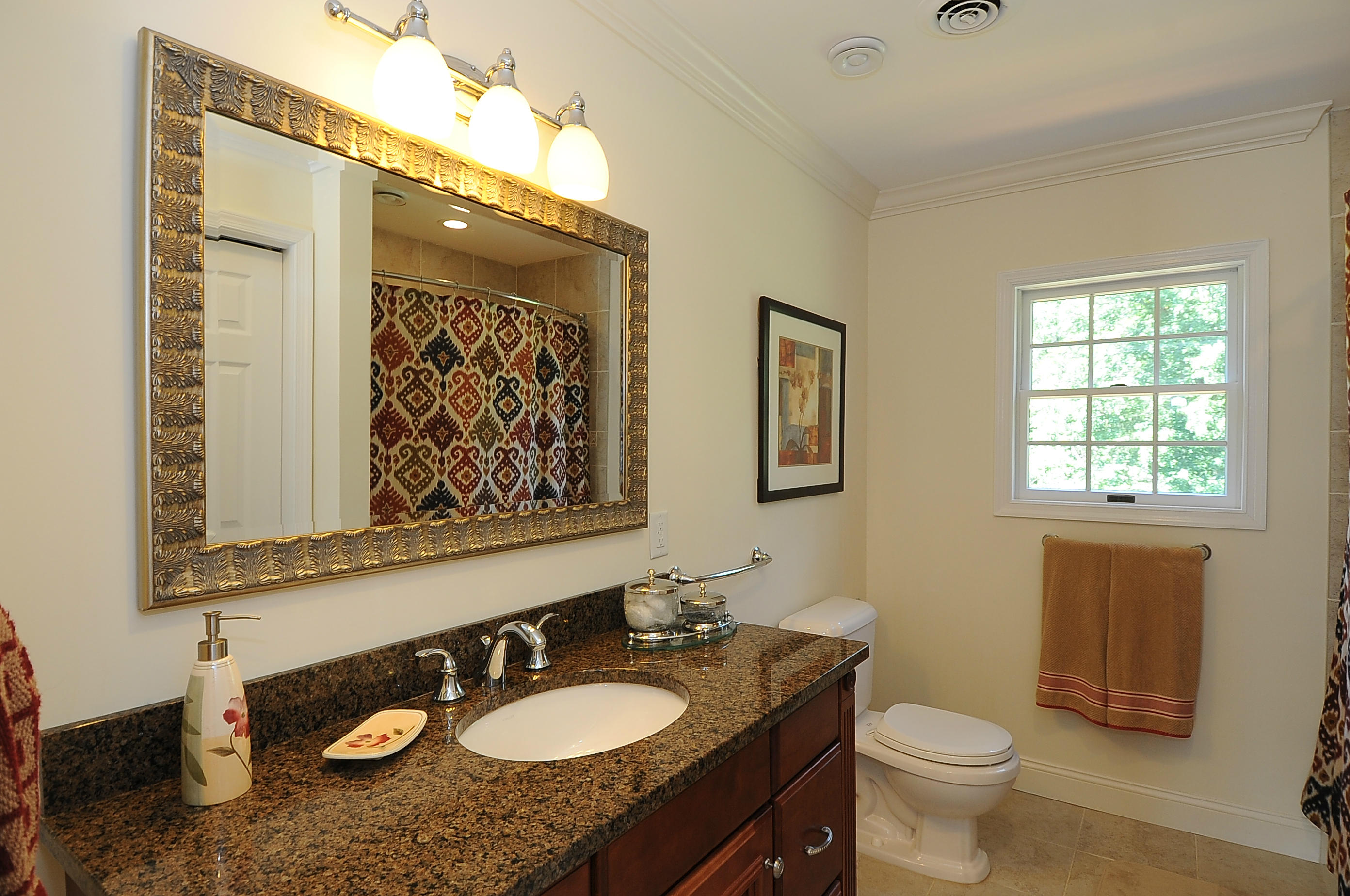 54 Conrad Road New Canaan, CT 06840 - Photo 18 of 21 a bathroom with a granite countertop sink toilet and mirror