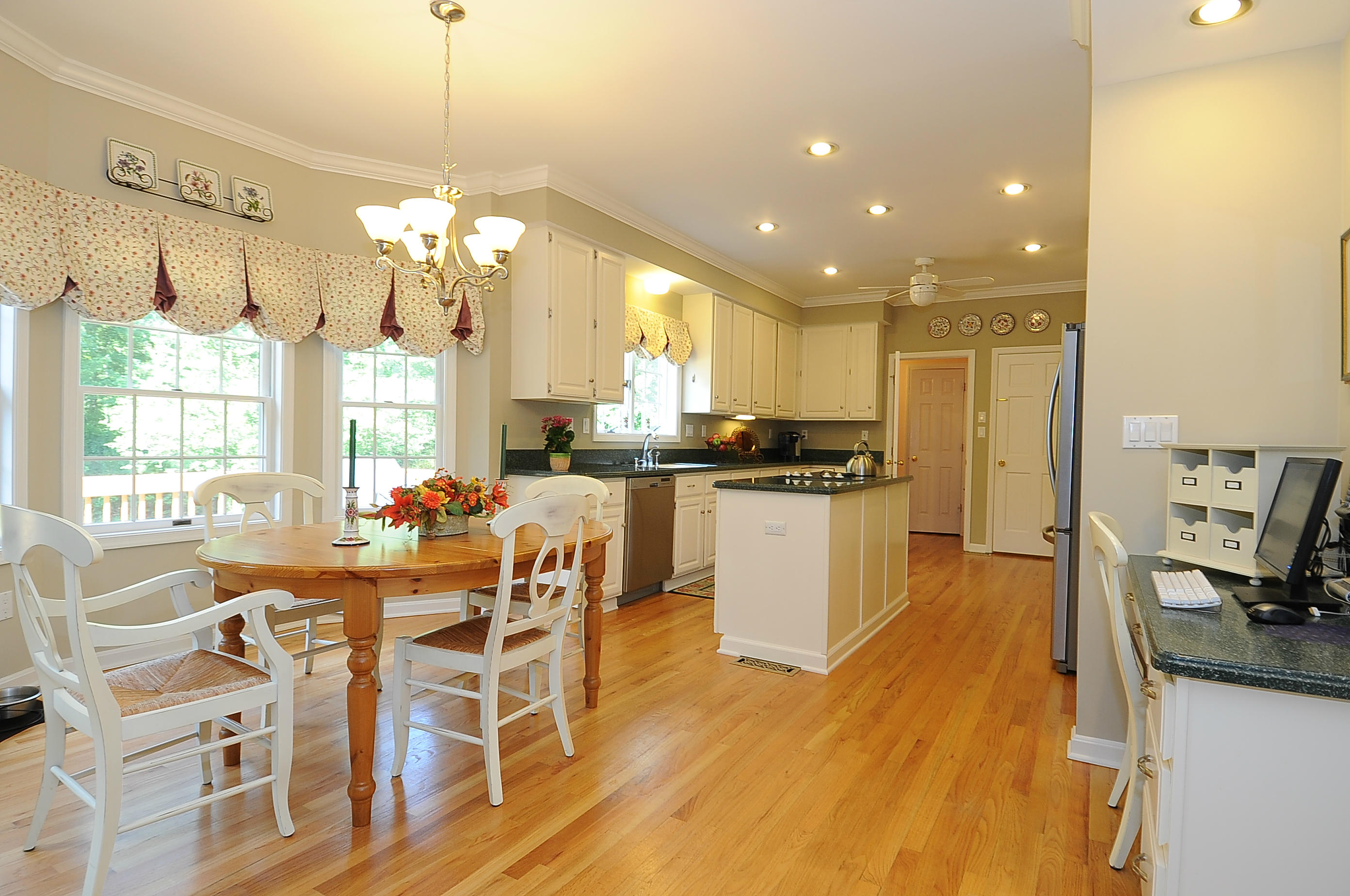 54 Conrad Road New Canaan, CT 06840 - Photo 6 of 21 a view of a dining room and livingroom with furniture wooden floor a chandelier