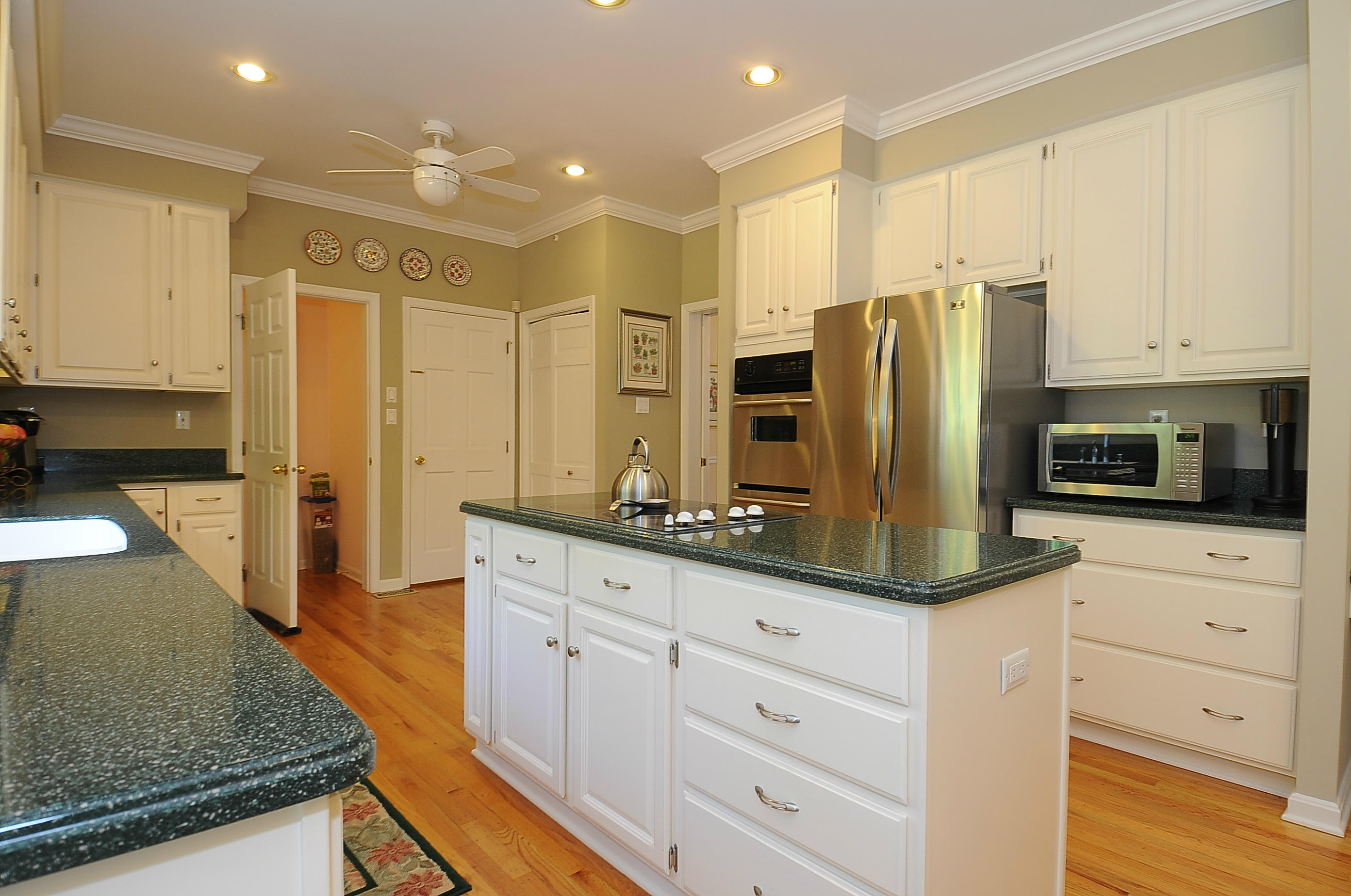 54 Conrad Road New Canaan, CT 06840 - Photo 7 of 21 a kitchen with stainless steel appliances kitchen island granite countertop a refrigerator and cabinets