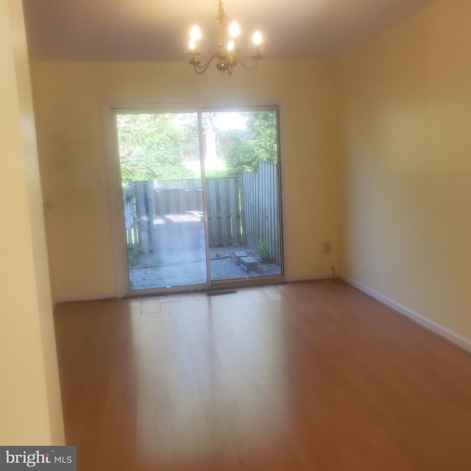 9202 Weathervane Place Montgomery Village, MD 20886 - Photo 18 of 71 a view of a room with wooden floor and window