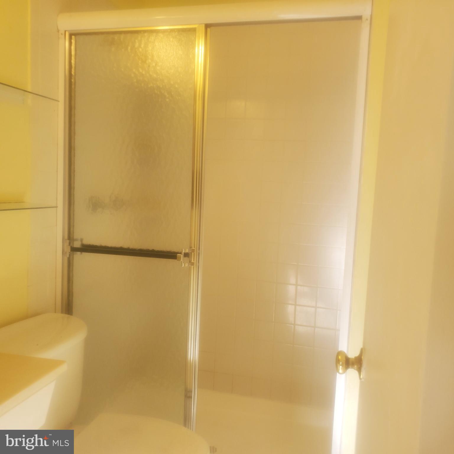 9202 Weathervane Place Montgomery Village, MD 20886 - Photo 26 of 71 a bathroom with a glass shower door