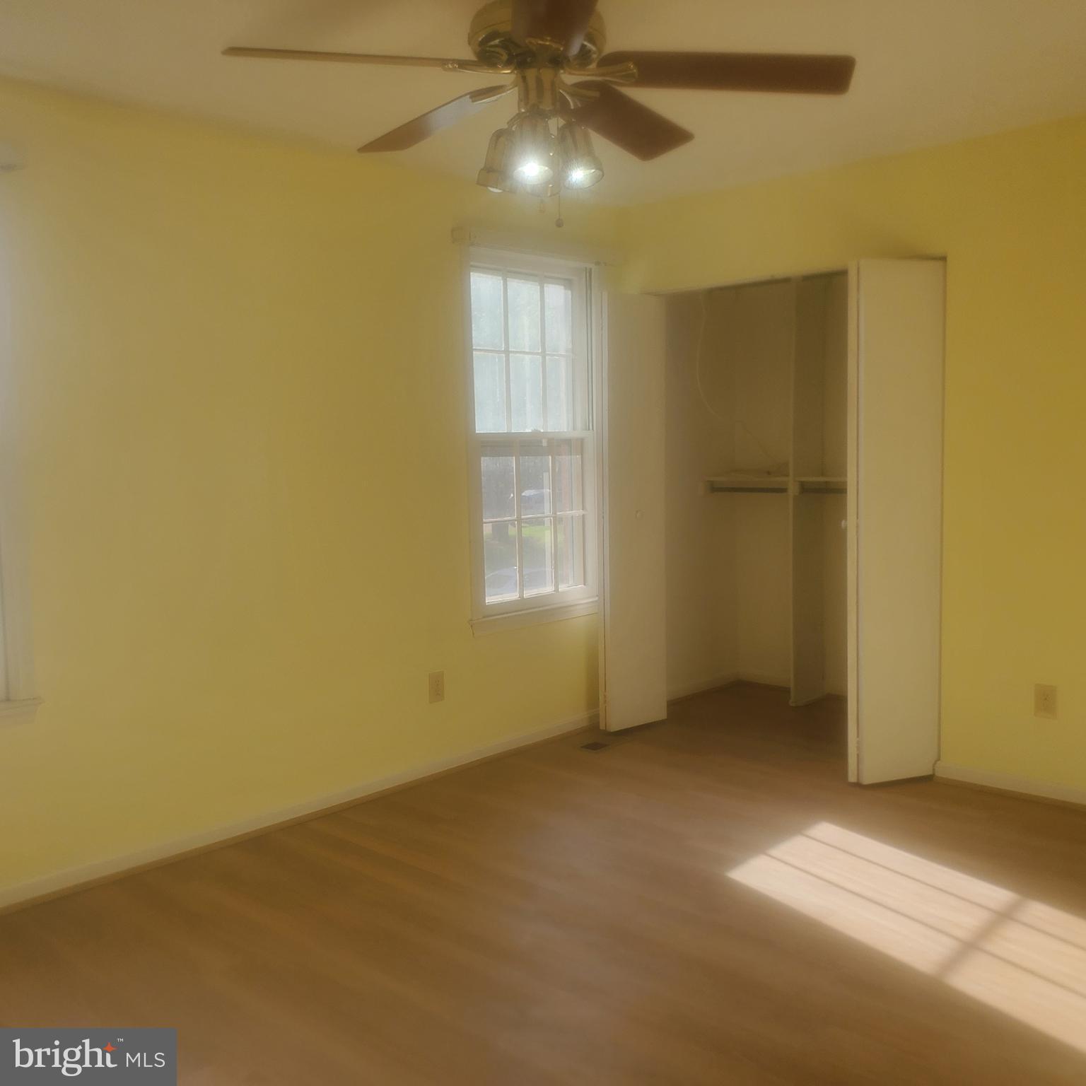9202 Weathervane Place Montgomery Village, MD 20886 - Photo 32 of 71 a view of an empty room with chandelier fan and a window