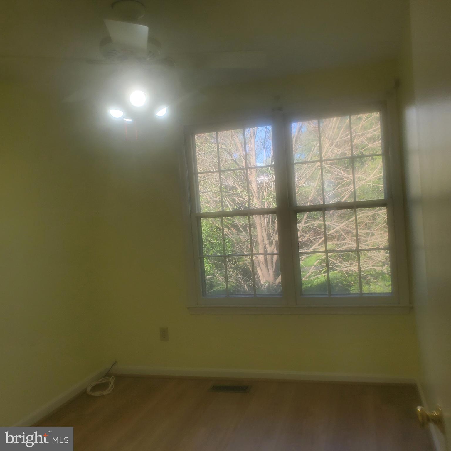 9202 Weathervane Place Montgomery Village, MD 20886 - Photo 41 of 71 an empty room with wooden floor and windows