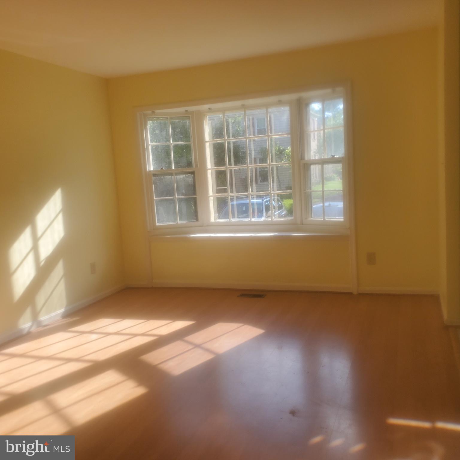 9202 Weathervane Place Montgomery Village, MD 20886 - Photo 44 of 71 a view of an empty room with wooden floor and a window
