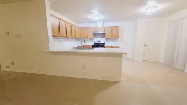 a view of a kitchen with a sink cabinets and a window