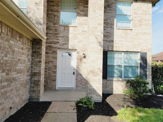 a view of a brick house with a large windows