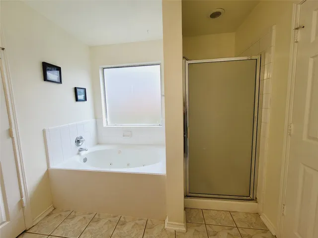 a bathroom with a bathtub and a shower