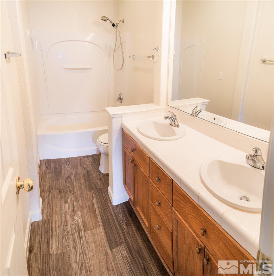 10490 Arbor Way Reno, NV 89521 - Photo 16 of 23 a spacious bathroom with a sink a toilet and a mirror
