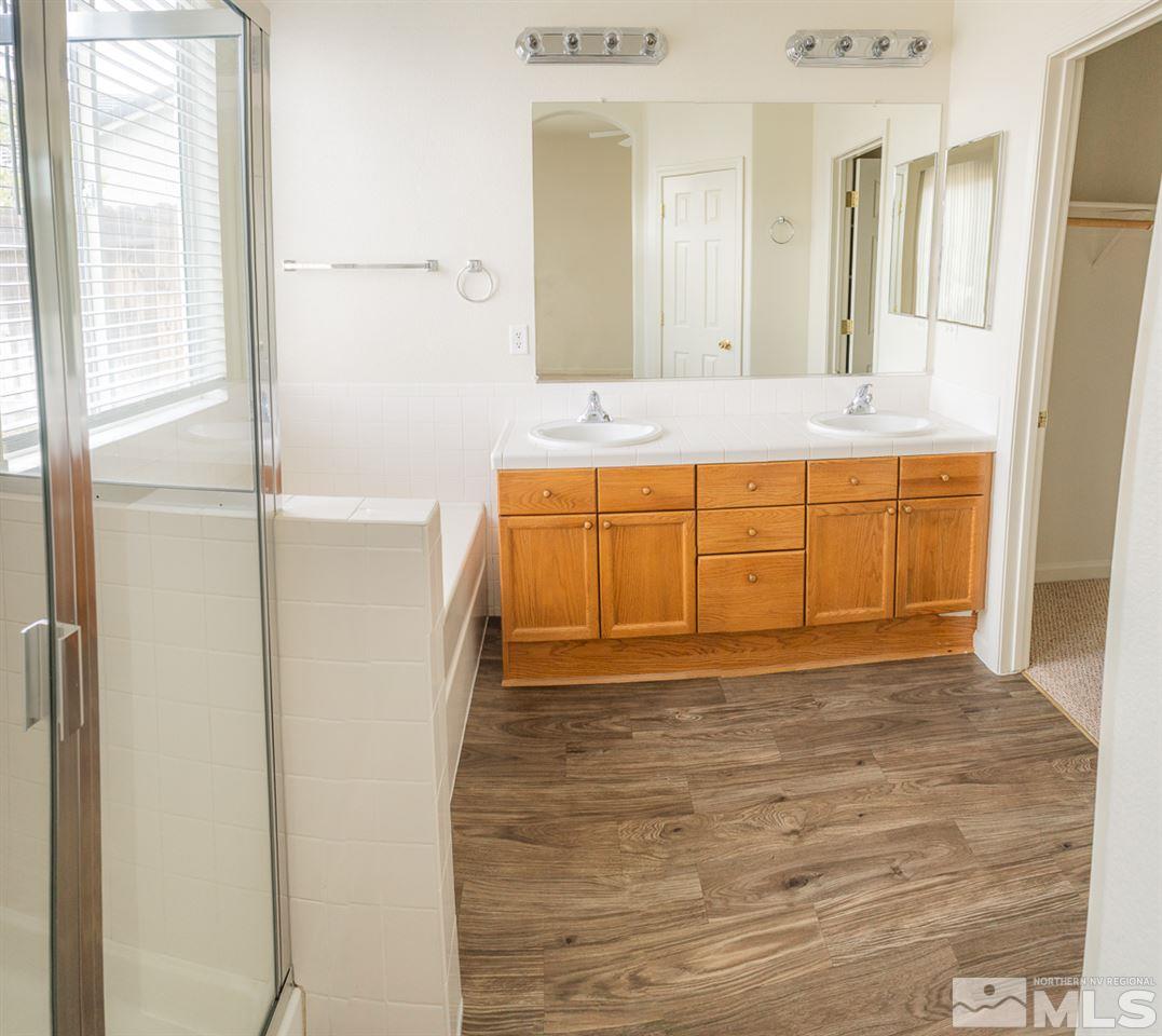 10490 Arbor Way Reno, NV 89521 - Photo 10 of 23 a bathroom with a tub sink and mirror